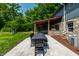 Expansive backyard featuring an outdoor dining area, a playground, and a charming covered patio with a fireplace at 3715 Rolling Springs Dr, Carmel, IN 46033