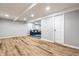 Spacious finished basement featuring light gray walls and beautiful wood-look flooring throughout the space at 3715 Rolling Springs Dr, Carmel, IN 46033