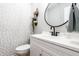 Charming powder room with stylish wallpaper, a modern black faucet, and a round mirror for added flair at 3715 Rolling Springs Dr, Carmel, IN 46033