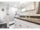 Modern bathroom with a walk-in shower, dark granite countertop, and contemporary fixtures at 3715 Rolling Springs Dr, Carmel, IN 46033