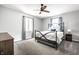 Cozy bedroom with a black iron bed frame, ceiling fan, and neutral color scheme creating a relaxing atmosphere at 3715 Rolling Springs Dr, Carmel, IN 46033