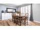 Elegant dining area with wood floors, table, chairs, and a built-in sideboard at 3715 Rolling Springs Dr, Carmel, IN 46033