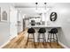 Modern eat-in kitchen bar featuring white countertops, seating for three, and stylish pendant lighting at 3715 Rolling Springs Dr, Carmel, IN 46033