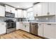 Modern kitchen features stainless appliances, white cabinetry, quartz countertops and a farmhouse sink at 3715 Rolling Springs Dr, Carmel, IN 46033