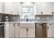 Farmhouse sink is framed by white cabinets and subway tile to create this bright and modern kitchen space at 3715 Rolling Springs Dr, Carmel, IN 46033