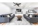 Inviting living room with sofas, coffee table, ceiling fan, and modern decor at 3715 Rolling Springs Dr, Carmel, IN 46033