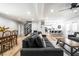 Spacious living room showcasing open-concept design, adjacent to staircase, dining area and bright modern kitchen at 3715 Rolling Springs Dr, Carmel, IN 46033