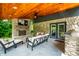 Inviting outdoor living space featuring a fireplace, TV, comfortable seating, and an outdoor grill at 3715 Rolling Springs Dr, Carmel, IN 46033