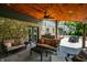 Inviting covered patio with stone accents, cozy seating, and an outdoor grill perfect for entertaining and relaxing at 3715 Rolling Springs Dr, Carmel, IN 46033