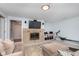 Finished basement with tan sofa, fireplace and exercise machine at 3740 Cheviot Pl, Indianapolis, IN 46205