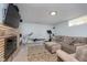 Finished basement featuring a brick fireplace, TV, lounge area, and workout equipment at 3740 Cheviot Pl, Indianapolis, IN 46205