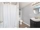 Bright bathroom with a shower behind a curtain, stylish vanity, and updated fixtures at 3740 Cheviot Pl, Indianapolis, IN 46205