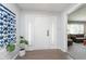 Welcoming entryway with tiled floors, a white door, and a decorative plant at 3740 Cheviot Pl, Indianapolis, IN 46205