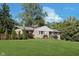 Well-maintained brick home featuring a lush front lawn, mature trees, and tasteful landscaping at 3740 Cheviot Pl, Indianapolis, IN 46205