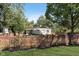 Charming home with a fenced yard, mature trees, and lush green grass at 3740 Cheviot Pl, Indianapolis, IN 46205