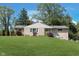 Charming brick ranch home with a lush green lawn and mature trees, offering a picturesque curb appeal at 3740 Cheviot Pl, Indianapolis, IN 46205
