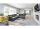 Bright living room boasts large windows, a comfortable sectional sofa, and stylish decor accents at 3740 Cheviot Pl, Indianapolis, IN 46205