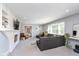 Bright living room with a fireplace, built-in shelving, and comfortable seating at 3740 Cheviot Pl, Indianapolis, IN 46205