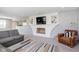 Inviting living room features a brick fireplace with built-in shelving and a modern, open-concept design at 3740 Cheviot Pl, Indianapolis, IN 46205