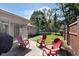 Relaxing patio area with three red Adirondack chairs overlooking the backyard at 3740 Cheviot Pl, Indianapolis, IN 46205