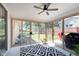 Light-filled sunroom with floor-to-ceiling glass doors that overlook a backyard at 3740 Cheviot Pl, Indianapolis, IN 46205