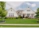 Beautiful exterior elevation with a manicured lawn, landscaping, and attractive architectural details at 3821 Shady Lake Dr, Westfield, IN 46074