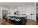 Kitchen with black island, white countertops, pendant lighting, and stainless steel appliances at 3821 Shady Lake Dr, Westfield, IN 46074
