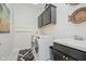 Well-lit laundry room features front-load machines, upper cabinets, and stylish black and white rug at 3821 Shady Lake Dr, Westfield, IN 46074