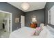 This main bedroom features gray walls, a unique chandelier, and a stylish antique vanity at 3821 Shady Lake Dr, Westfield, IN 46074