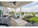 Covered patio area with comfortable seating, overlooking the pool and pond at 3821 Shady Lake Dr, Westfield, IN 46074