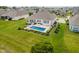 An aerial view of the pool with lush backyard landscaping and patio seating in a beautiful neighborhood at 3821 Shady Lake Dr, Westfield, IN 46074