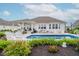 Outdoor pool with patio furniture surrounded by manicured landscaping in backyard at 3821 Shady Lake Dr, Westfield, IN 46074
