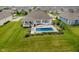 Aerial view of the backyard pool with patio furniture and landscaped garden in a suburban community at 3821 Shady Lake Dr, Westfield, IN 46074