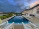 Backyard pool featuring an amazing sunset view of the outdoor patio and seating area by the lake at 3821 Shady Lake Dr, Westfield, IN 46074
