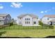 Fenced-in backyard features a well-maintained lawn and a gray two-story home at 4253 Ironclad Dr, Bargersville, IN 46106