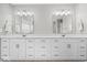 Bright bathroom boasts a double vanity with two mirrors and ample storage in white cabinets at 4253 Ironclad Dr, Bargersville, IN 46106
