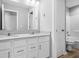 Bright bathroom boasts a double vanity with white cabinets and a combined shower and toilet at 4253 Ironclad Dr, Bargersville, IN 46106