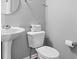 Bathroom featuring a pedestal sink, toilet, and simple decor, providing a clean look at 4253 Ironclad Dr, Bargersville, IN 46106