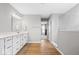 Bright bathroom boasts wood-look floors, double vanity, and stunning marble shower with glass door at 4253 Ironclad Dr, Bargersville, IN 46106