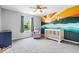 Vibrant Bedroom with playful wall mural, crib, comfortable chair, and plenty of natural light at 4253 Ironclad Dr, Bargersville, IN 46106