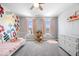Bright bedroom with floral wall mural, pink accents, and plenty of natural light at 4253 Ironclad Dr, Bargersville, IN 46106