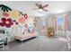 Bright bedroom with playful wall mural, pink accents, and plenty of natural light at 4253 Ironclad Dr, Bargersville, IN 46106