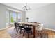 Dining room featuring a dark wood table, large bay window, and modern chandelier at 4253 Ironclad Dr, Bargersville, IN 46106