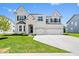 Beautiful two-story home with brick exterior, three-car garage, and well-manicured lawn at 4253 Ironclad Dr, Bargersville, IN 46106