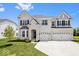 Beautiful two-story home with brick exterior, three-car garage, and well-manicured lawn at 4253 Ironclad Dr, Bargersville, IN 46106