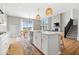 Open kitchen and living area featuring a large island, modern lighting, and a fireplace at 4253 Ironclad Dr, Bargersville, IN 46106