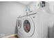 A modern laundry room with a white washer and dryer set at 4253 Ironclad Dr, Bargersville, IN 46106