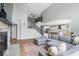 Open-concept living area with fireplace, staircase, and a modern gray sectional sofa at 4253 Ironclad Dr, Bargersville, IN 46106