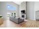 Spacious living room with stone fireplace, tall windows, and a comfortable sectional sofa at 4253 Ironclad Dr, Bargersville, IN 46106