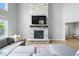 Bright living room featuring a stone fireplace, mounted TV, and plush sectional sofa at 4253 Ironclad Dr, Bargersville, IN 46106